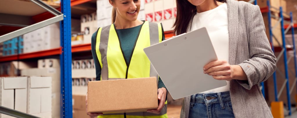 Photo of employer speaking to insurance agent