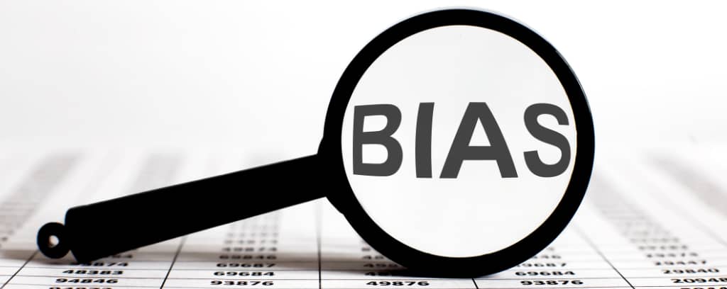 Photo of magnifying glass revealing bias in data