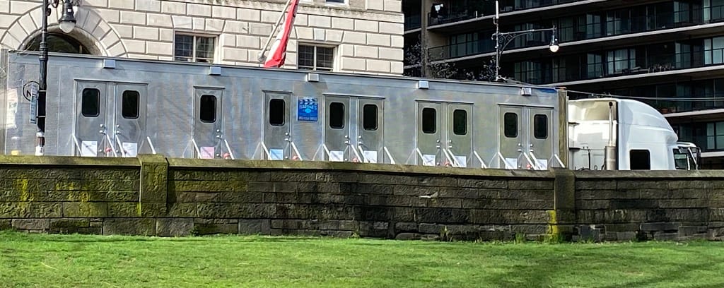 Photo of trailers for a film set outside Central Park.