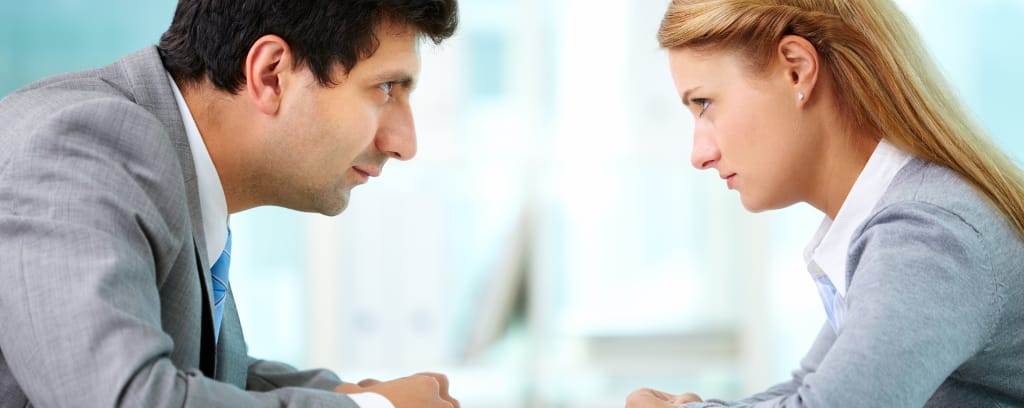 Two business people facing each other in a dispute.