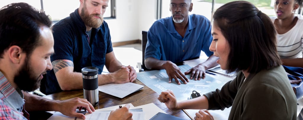 Photo of employees engaged in collaboration
