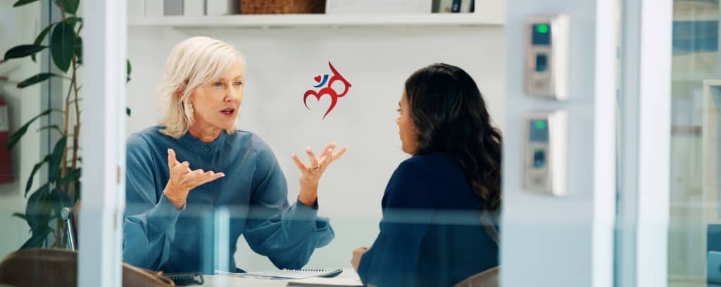 Photo of two people at work having a difficult conversation
