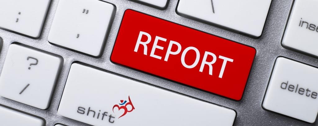 Photo of computer keyboard with red "Report" button