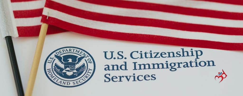 Photo of American flags atop US Citizenship and Immigration Services document