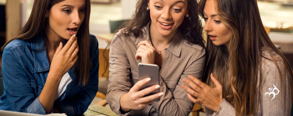 Photo of employees reading gossip on a smartphone