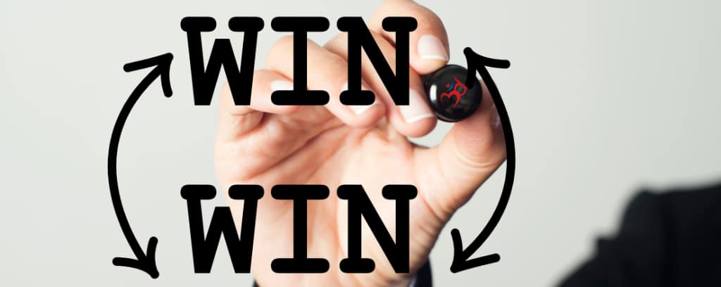 Photo of hand writing "Win Win" in black marker on a clear board