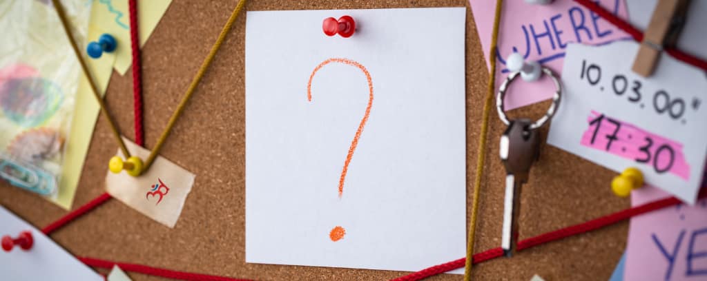 Photo of cork board with evidence and a piece of paper with a question mark