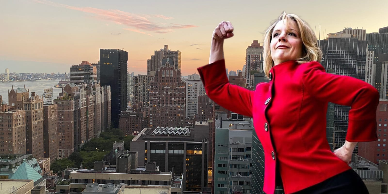 Photo of Nance L. Schick in triumphant pose with NYC skyline behind her.
