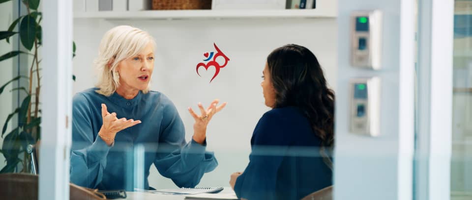 Photo of two people at work having a difficult conversation