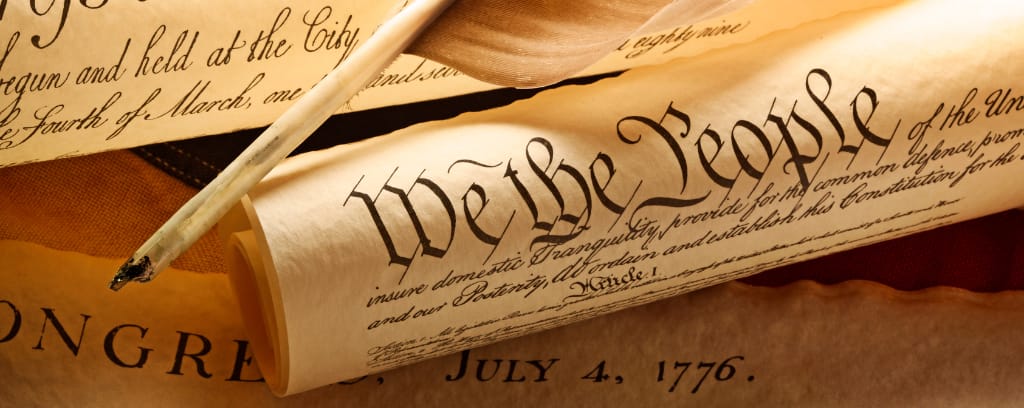 Photo of US Constitution scroll reading "We the People..."