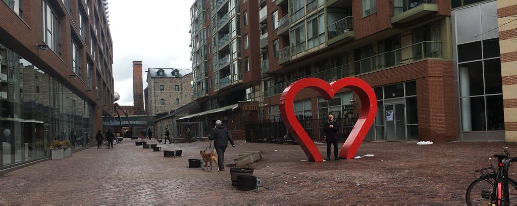 Photo of Musician Peter Schmitz inside a heart sculpture in Toronto's Distillery District.