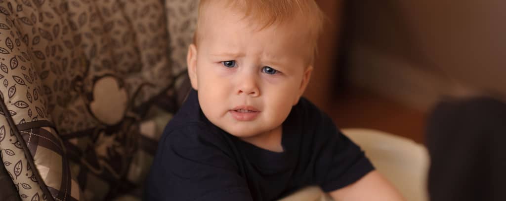 Photo of toddler with confused look: tilted head, scrunched brow.