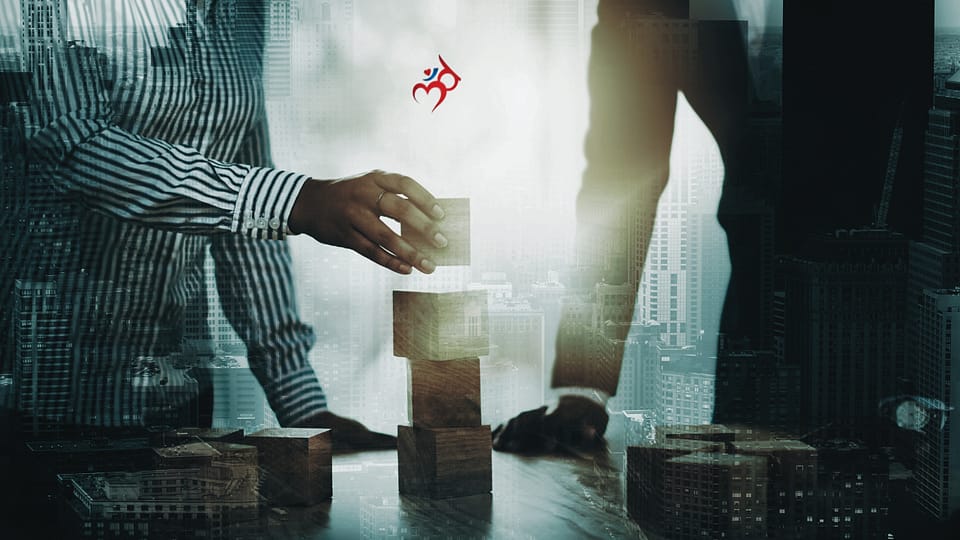 Photo of two business people stacking blocks